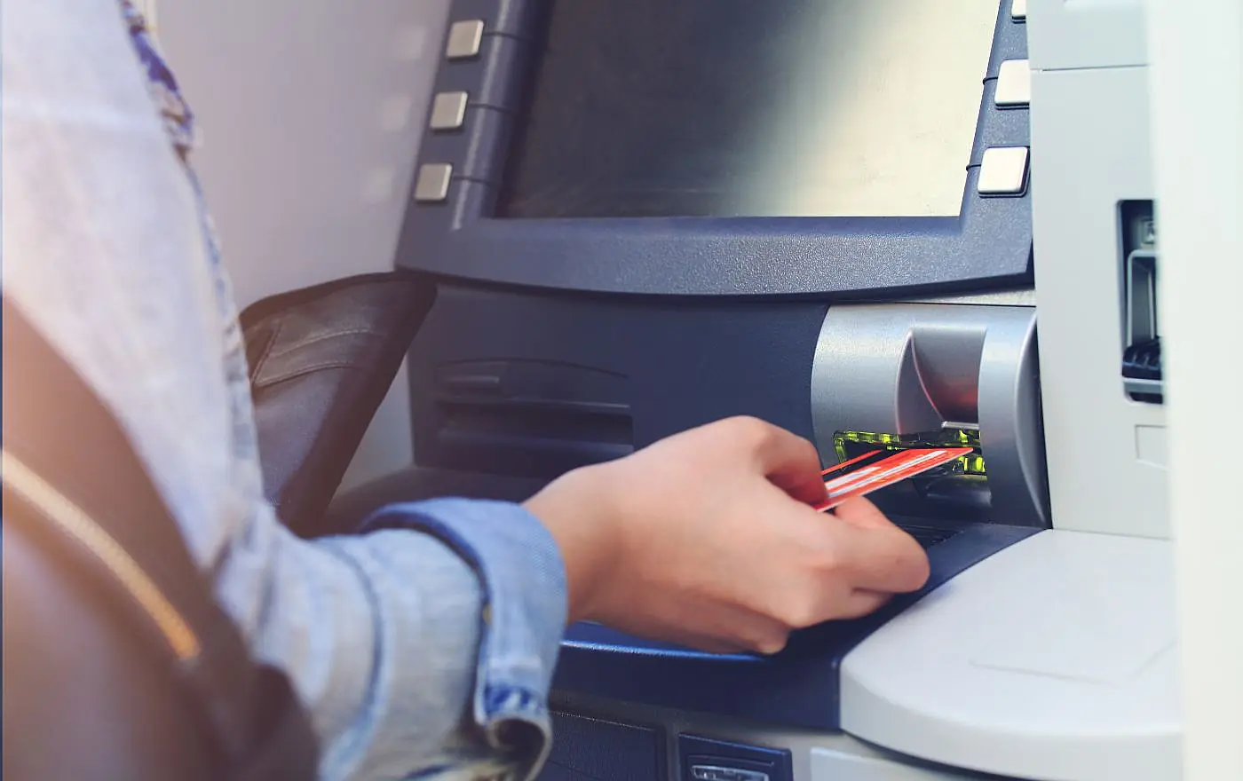 Person withdrawing cash from an ATM machine in Bali