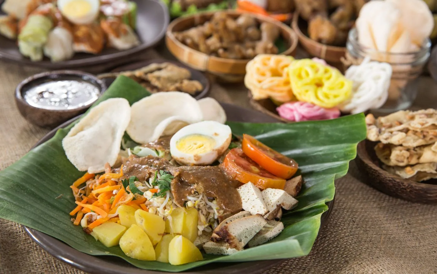 Gado Gado with colorful steamed vegetables, tofu, tempeh, egg, and creamy peanut sauce