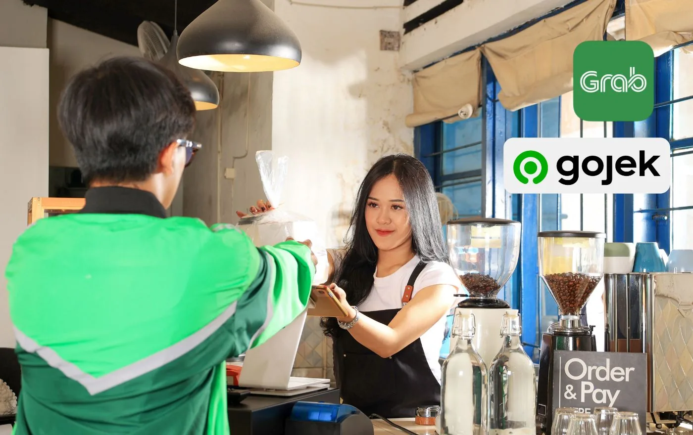 Grab food delivery driver picking up order at cafe in Bali