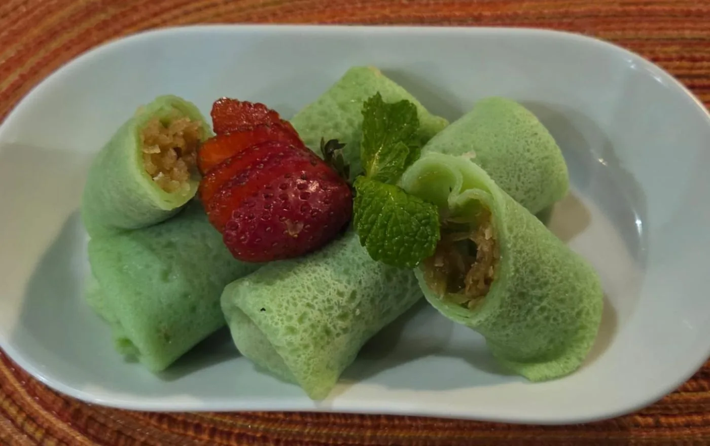 Kue Dadar green pandan crepe filled with sweet grated coconut and palm sugar