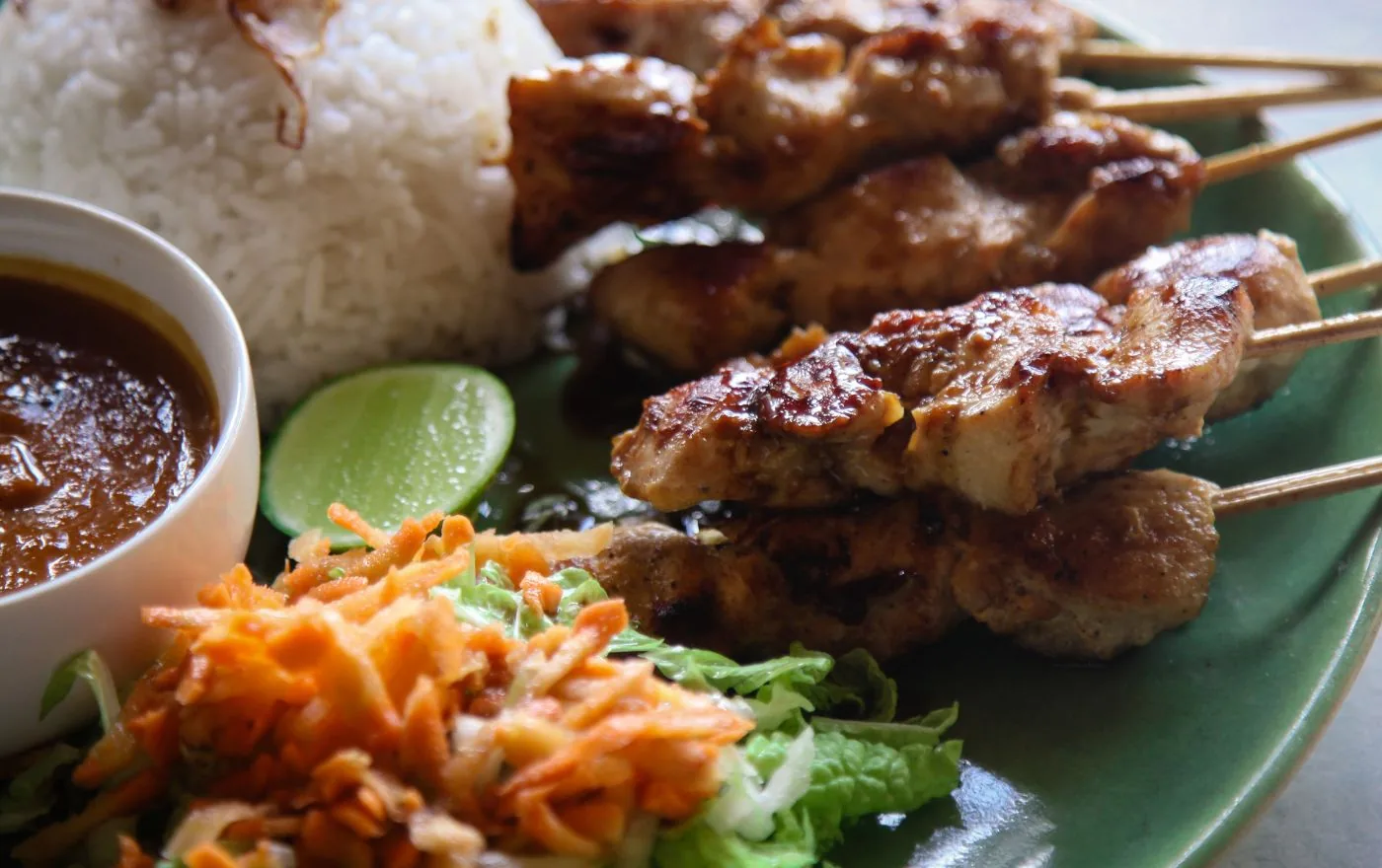 Sate Babi pork satay skewers grilled over charcoal with spicy peanut dipping sauce